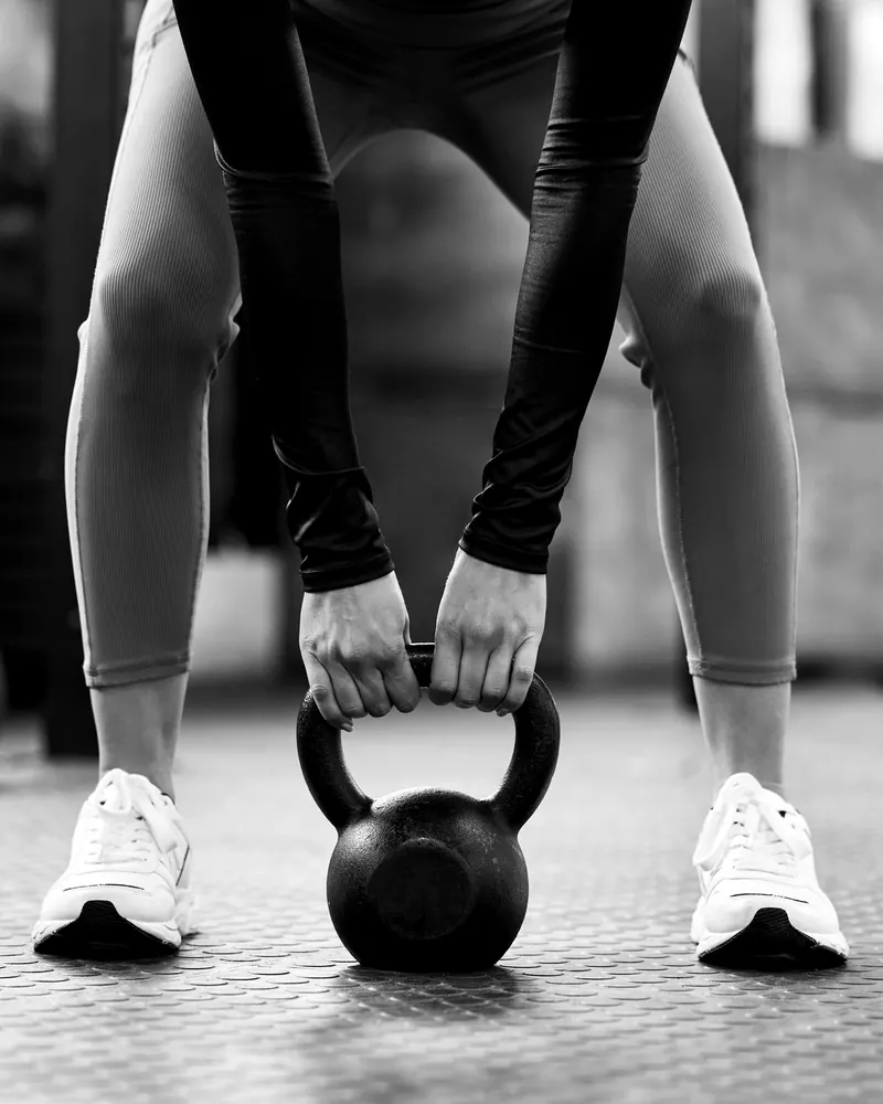 Learning to lift a kettlebell with good technique during a personal training session